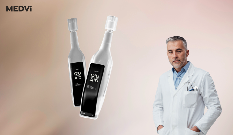 A physician in a white coat next to QUAD bottles